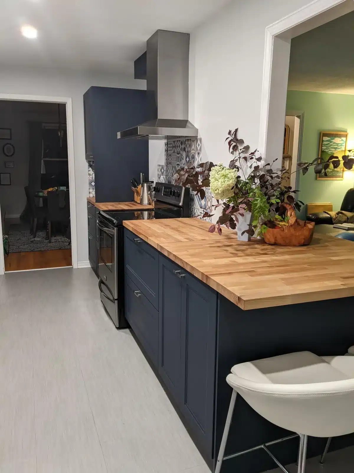 IKEA AXSTAD blue kitchen with a long butcher block peninsula