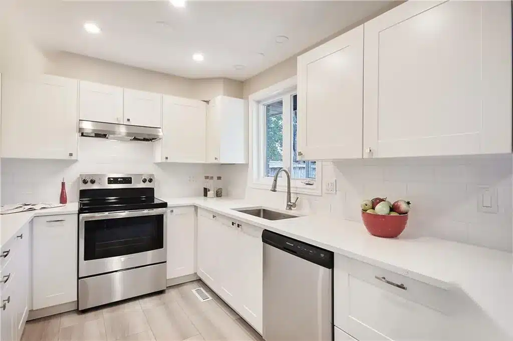 IKEA AXSTAD matt white kitchen with an undermount sink below a window