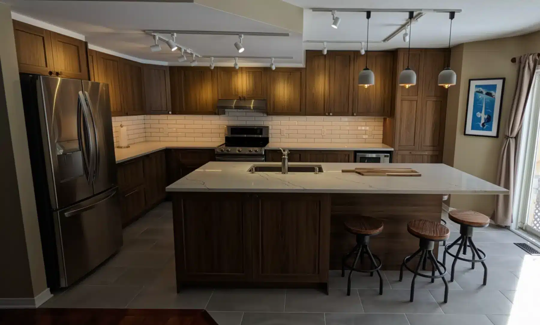 Finished IKEA kitchen in Ottawa with walnut-look shaker fronts, quartz island and white subway tile